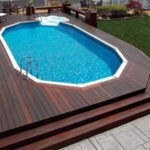 : above ground pools with decks around them