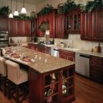 : cherry kitchen cabinets with black appliances