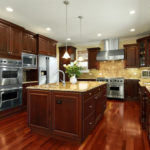 : cherry kitchen cabinets with wood floors