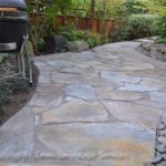 : flagstone patios with moss